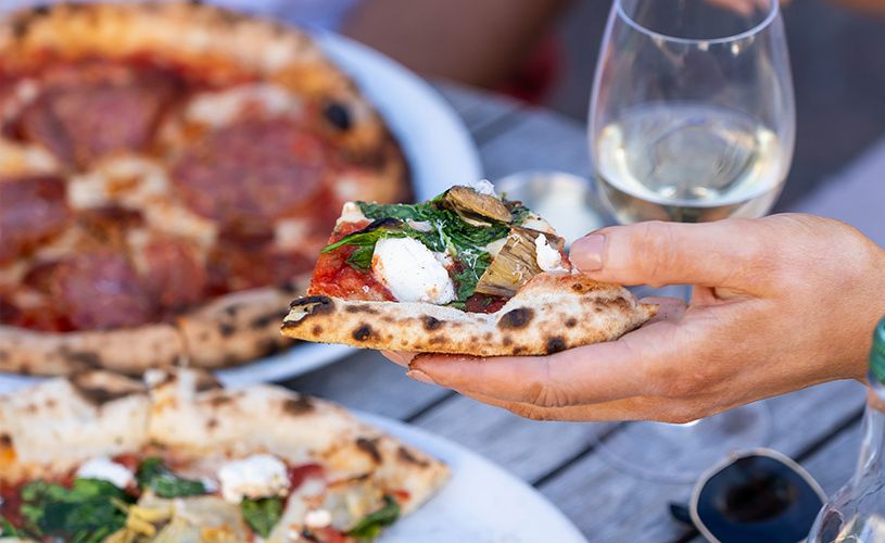 Bath Pizza Co - person picking up pizza slice